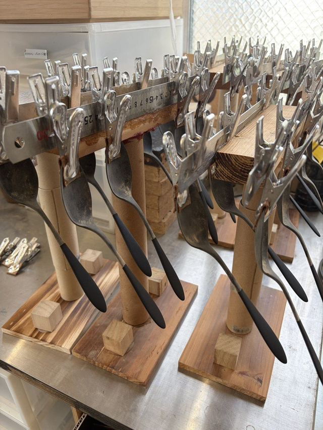 Freshly lacquered THE URUSHI spoons and forks on drying racks
